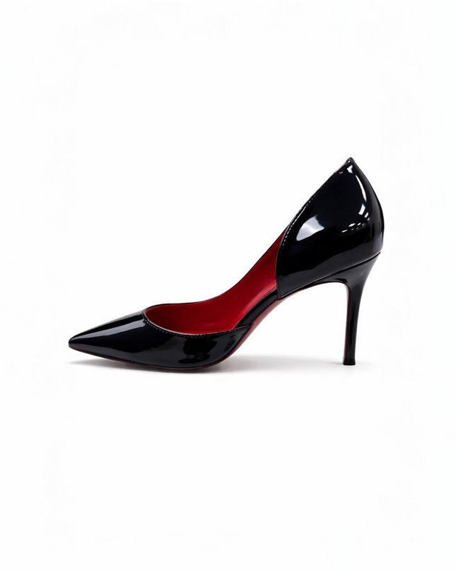 Black patent leather high-heeled shoe with a red sole.