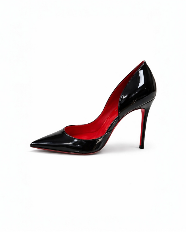 Black patent leather high-heeled shoe with a red sole.